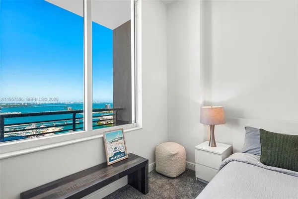 a bedroom with furniture and a window