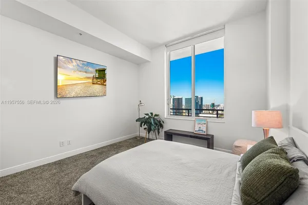 a bedroom with a bed and ceiling fan
