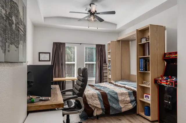 a bedroom with a bed and a chandelier