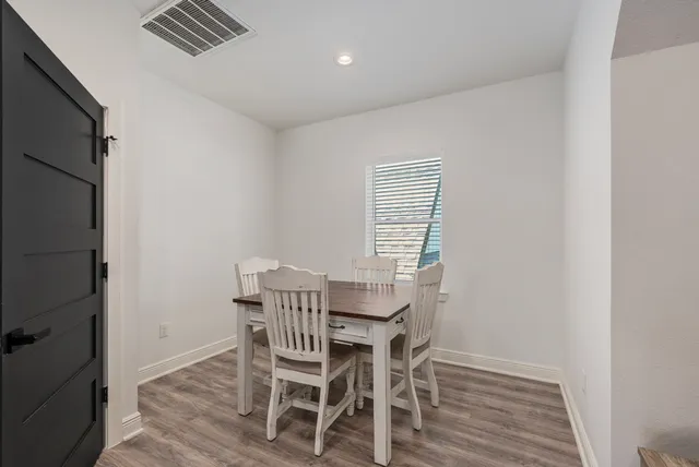 a dining room with furniture and window