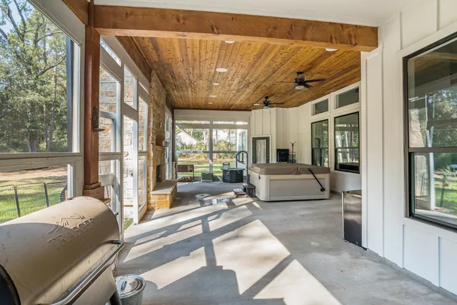 a living room with furniture and a floor to ceiling window