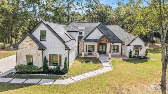 a front view of a house with yard and green space