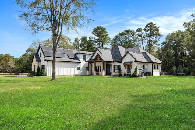 a house with a big yard and large trees