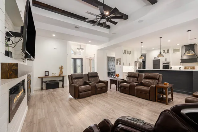 a living room with furniture flat screen tv and a fireplace