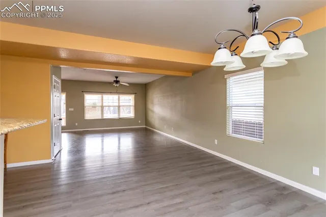 a view of a livingroom with wooden floor and a window