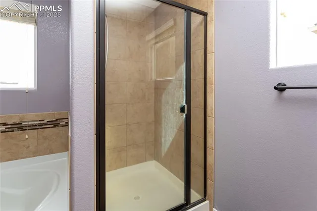 a bathroom with a glass shower door