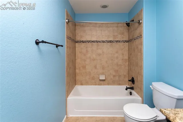 a bathroom with a toilet and a bathtub