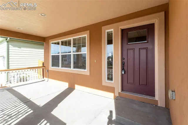 a view of a house that has a balcony and wooden floor