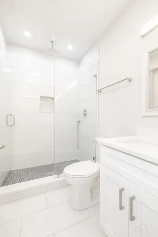 a bathroom with a toilet and a shower