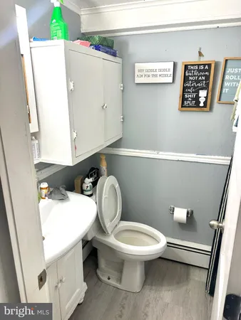 a bathroom with a toilet a sink and a mirror