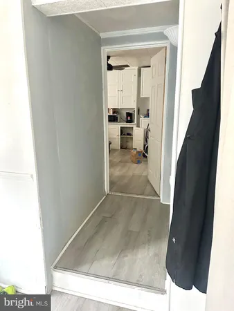 view of a living room with a sink and wooden floor