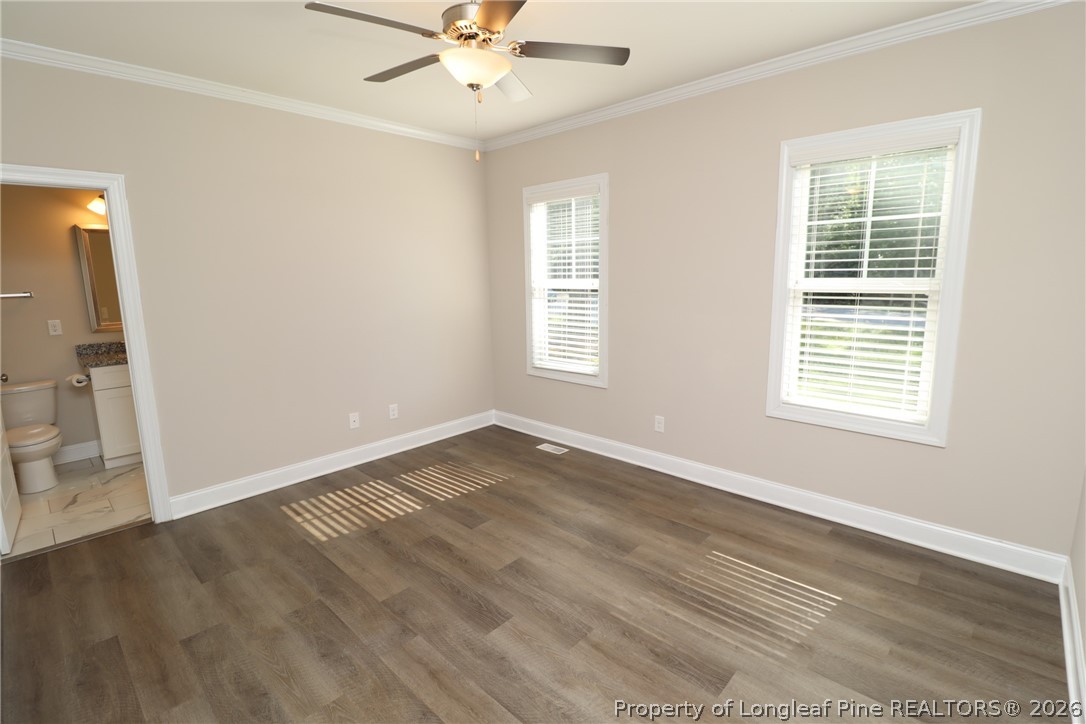 8424 Rhodes Road Apex, NC 27539 - Photo 19 of 31 wooden floor in an empty room with a window