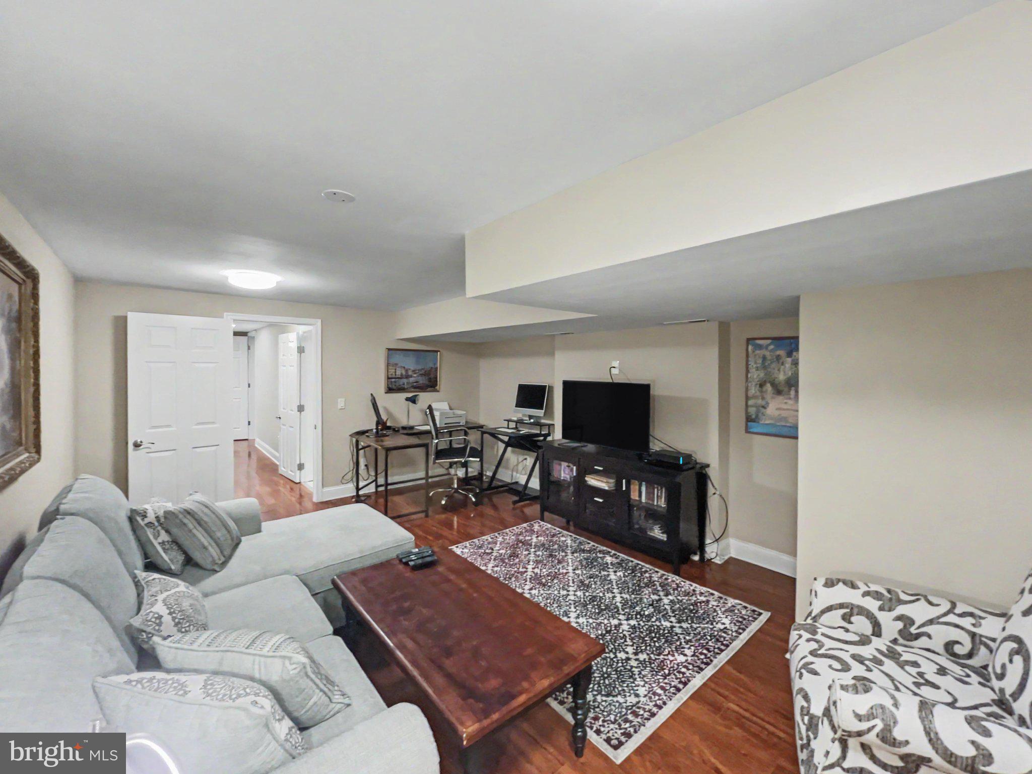 1610 North Broadway Baltimore, MD 21213 - Photo 12 of 18 a living room with furniture and a flat screen tv