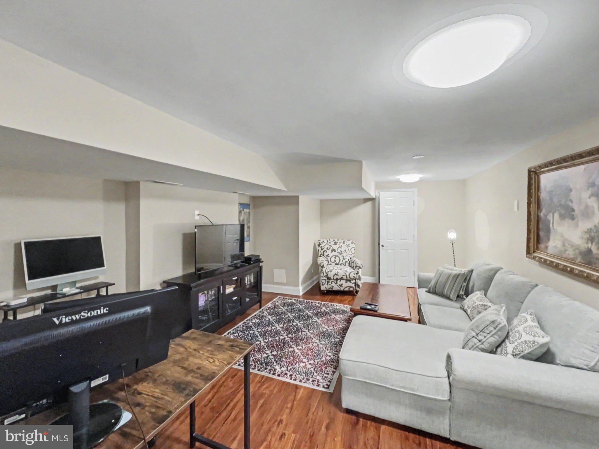 1610 North Broadway Baltimore, MD 21213 - Photo 13 of 18 a living room with furniture and a flat screen tv