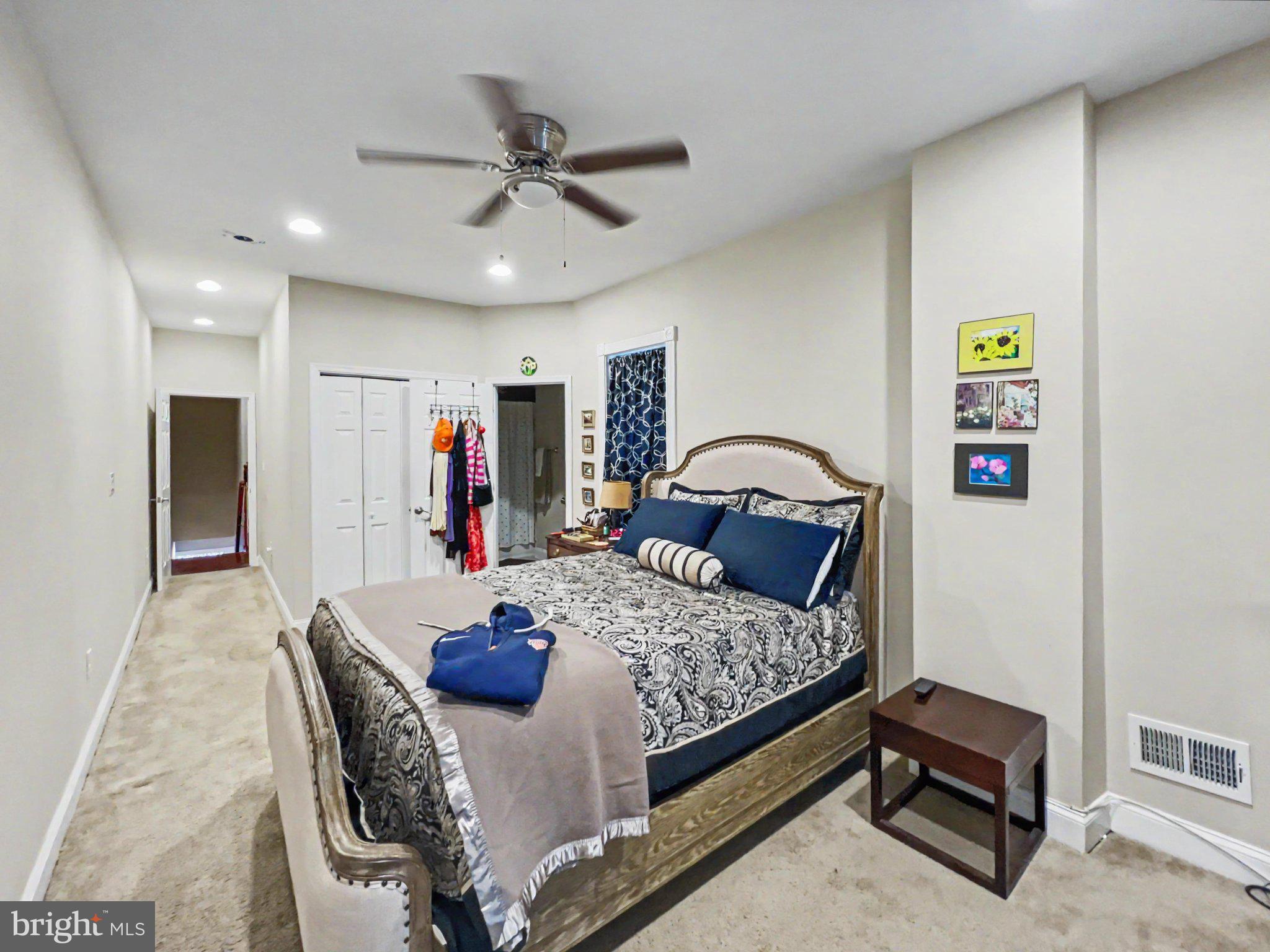 1610 North Broadway Baltimore, MD 21213 - Photo 15 of 18 a bedroom with a bed and a large mirror
