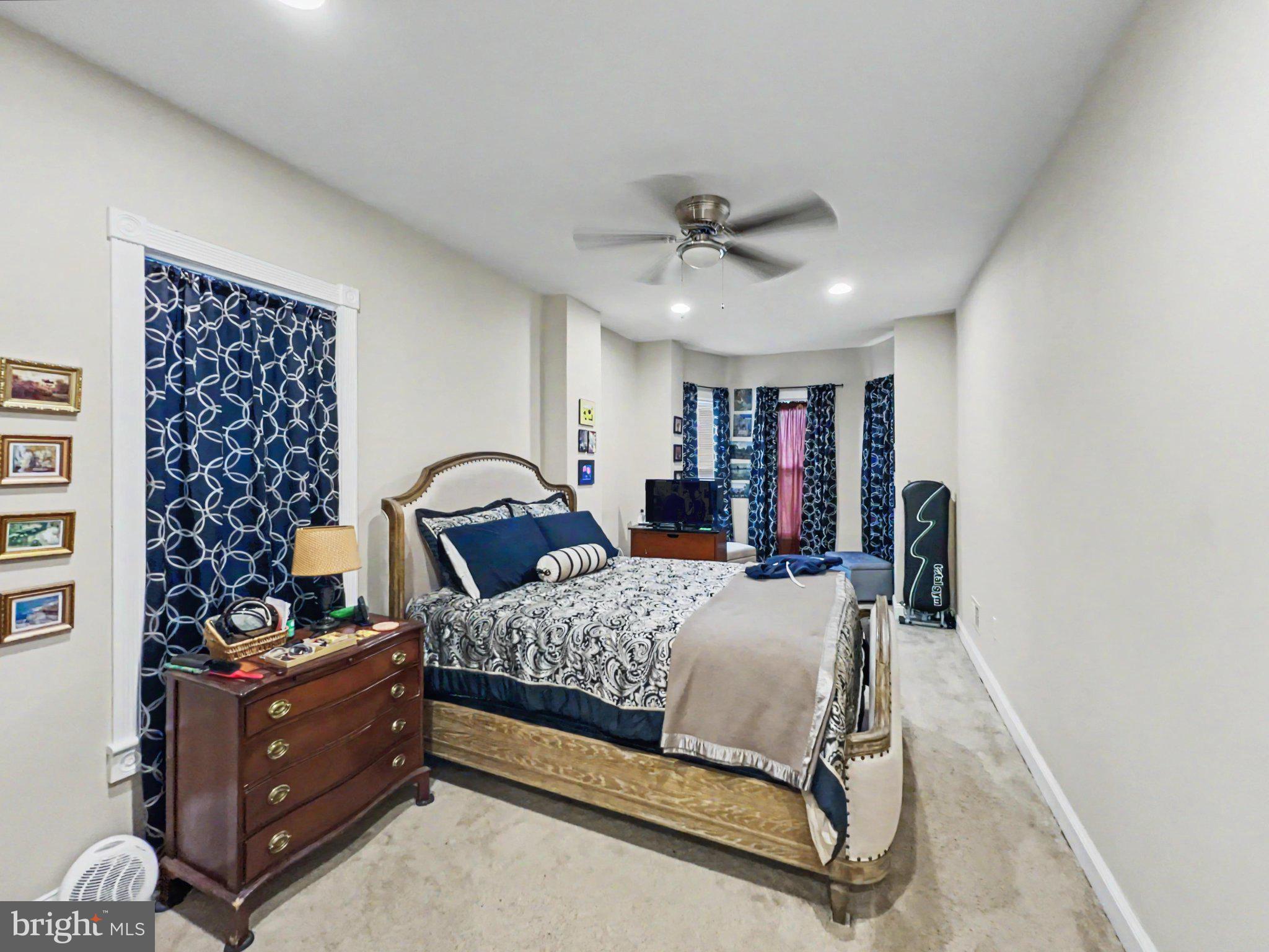1610 North Broadway Baltimore, MD 21213 - Photo 16 of 18 a bed room with a bed and a bookshelf
