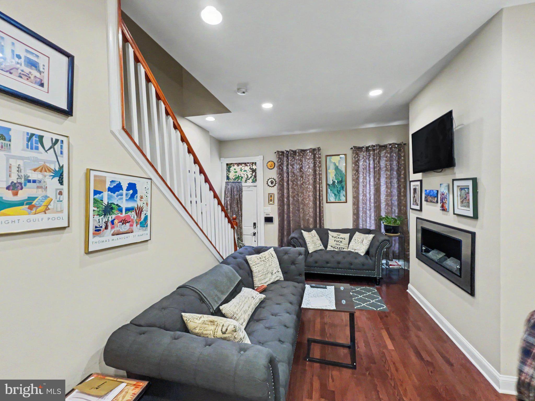 1610 North Broadway Baltimore, MD 21213 - Photo 3 of 18 a living room with furniture and a flat screen tv