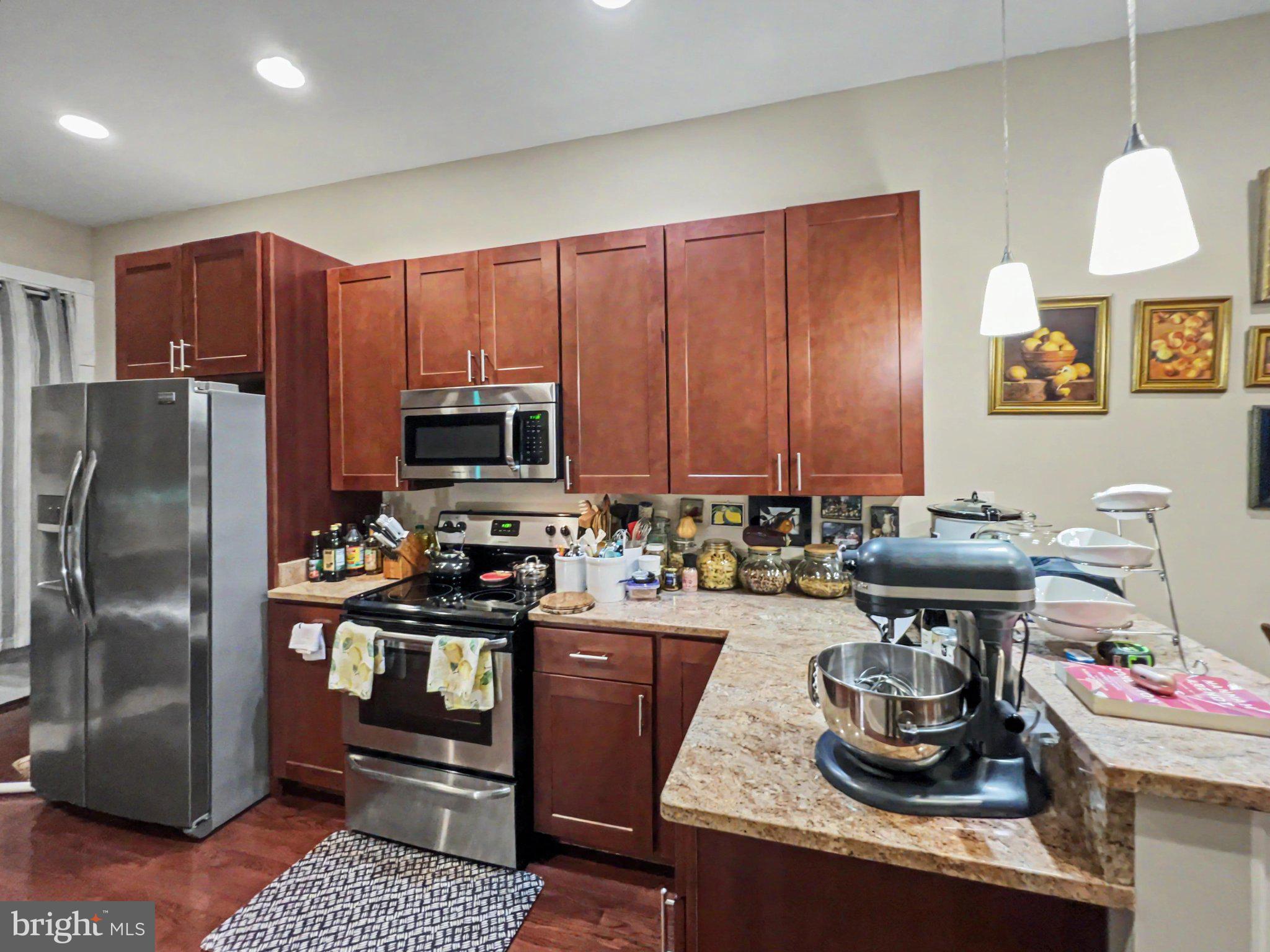 1610 North Broadway Baltimore, MD 21213 - Photo 5 of 18 a kitchen with a refrigerator and a stove