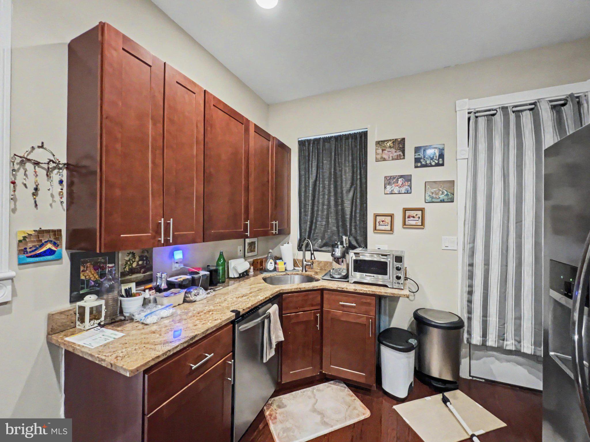 1610 North Broadway Baltimore, MD 21213 - Photo 6 of 18 a kitchen with a sink stove and refrigerator