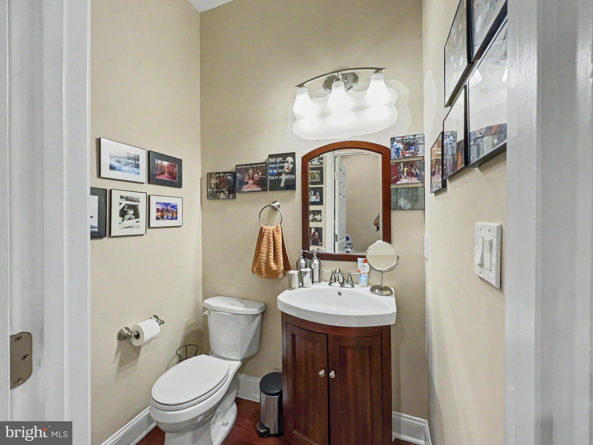 1610 North Broadway Baltimore, MD 21213 - Photo 8 of 18 a bathroom with a toilet sink and mirror