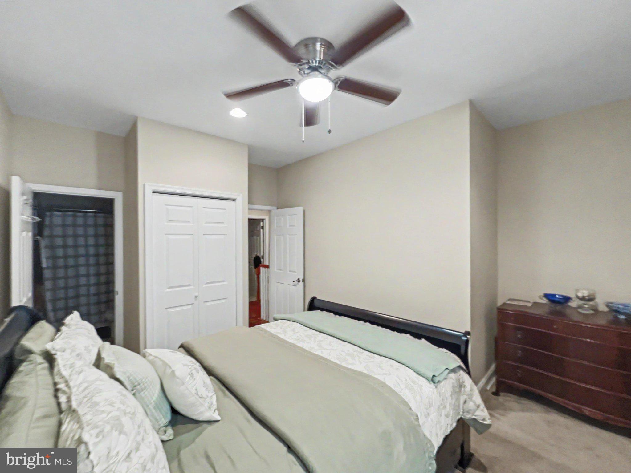 1610 North Broadway Baltimore, MD 21213 - Photo 9 of 18 a bedroom with a bed and a ceiling fan