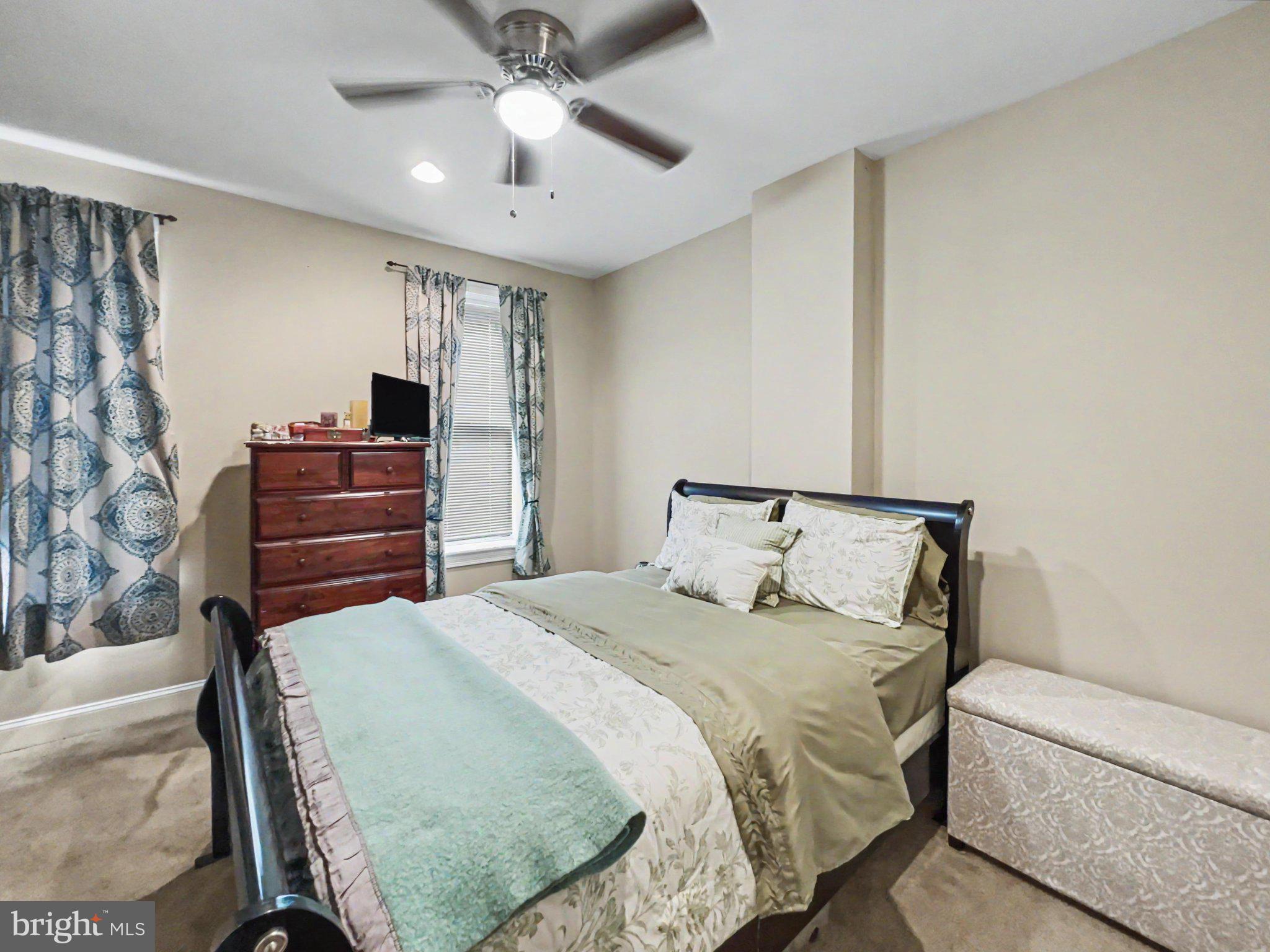 1610 North Broadway Baltimore, MD 21213 - Photo 10 of 18 a bedroom with a bed and ceiling fan