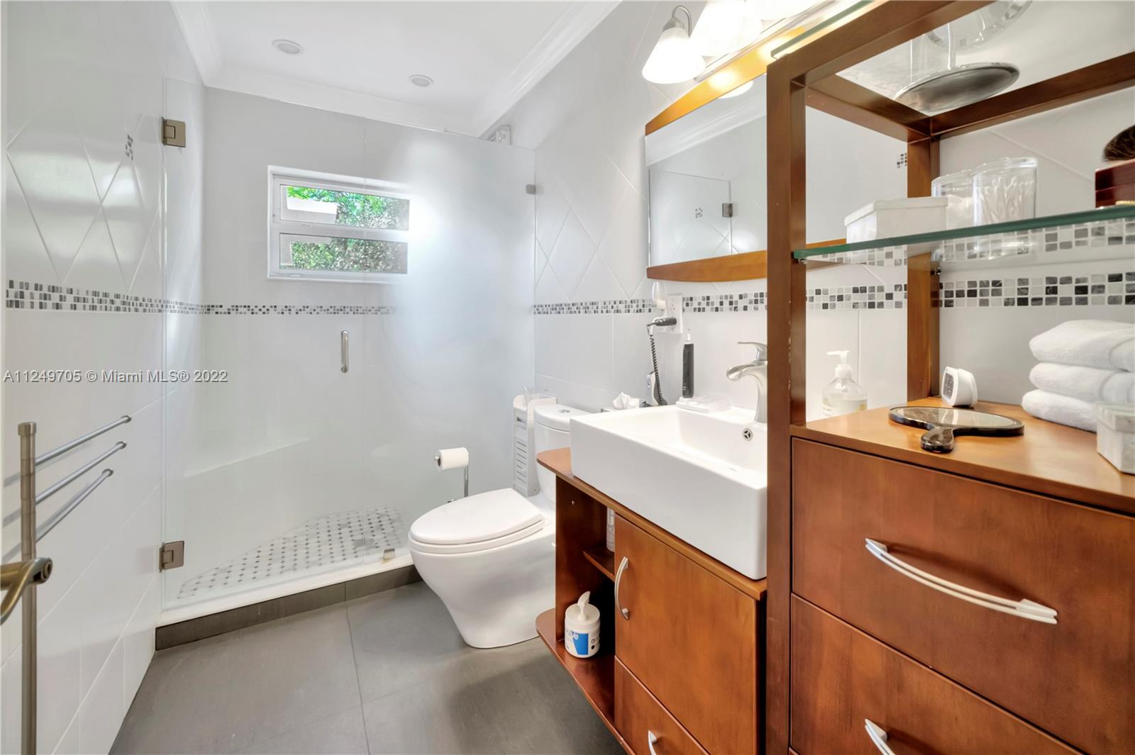 4290 Southwest 11th Street Miami, FL 33134 - Photo 13 of 20 a bathroom with a sink a toilet and mirror