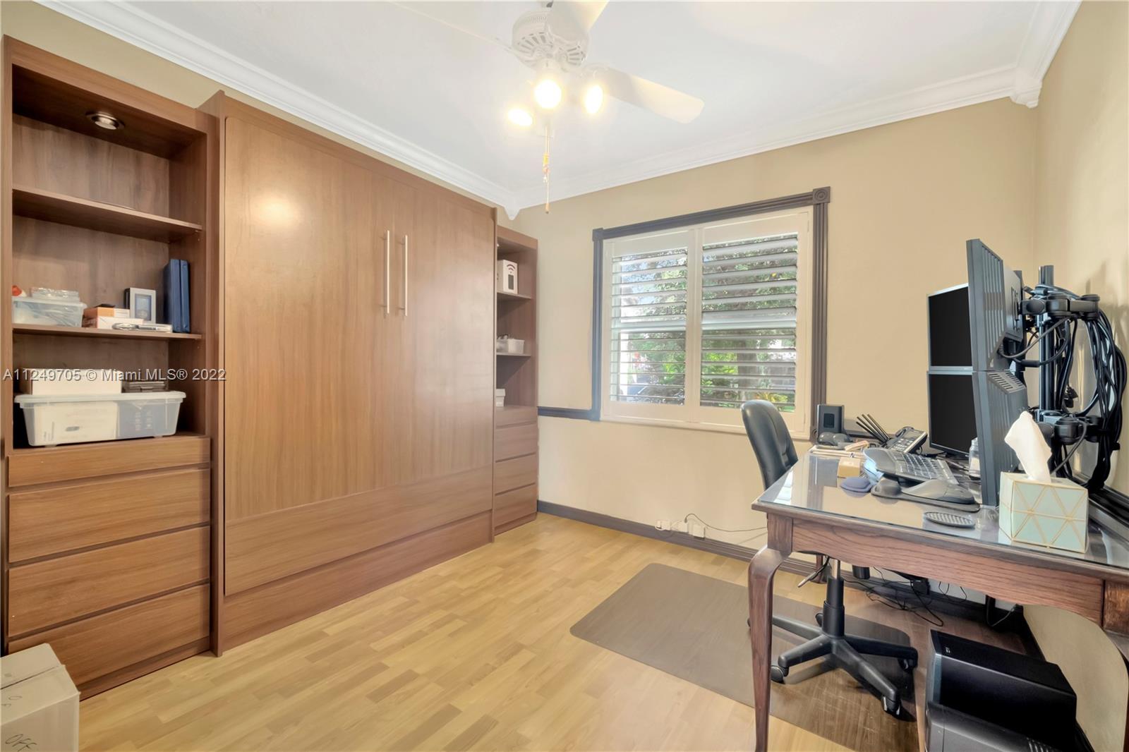 4290 Southwest 11th Street Miami, FL 33134 - Photo 16 of 20 a view of a workspace with furniture and a window