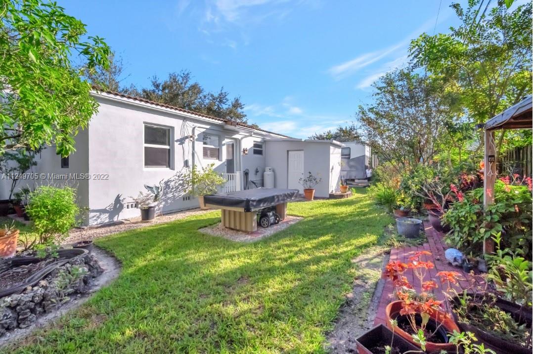 4290 Southwest 11th Street Miami, FL 33134 - Photo 20 of 20 a view of a patio with table and chairs potted plants and large tree