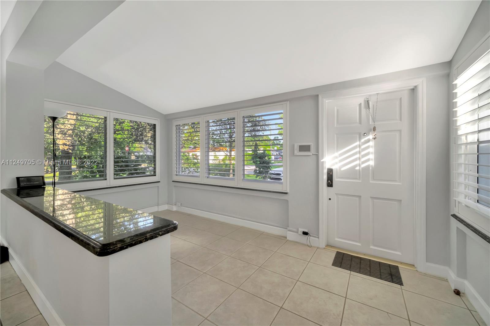 4290 Southwest 11th Street Miami, FL 33134 - Photo 4 of 20 a living room with furniture and large windows