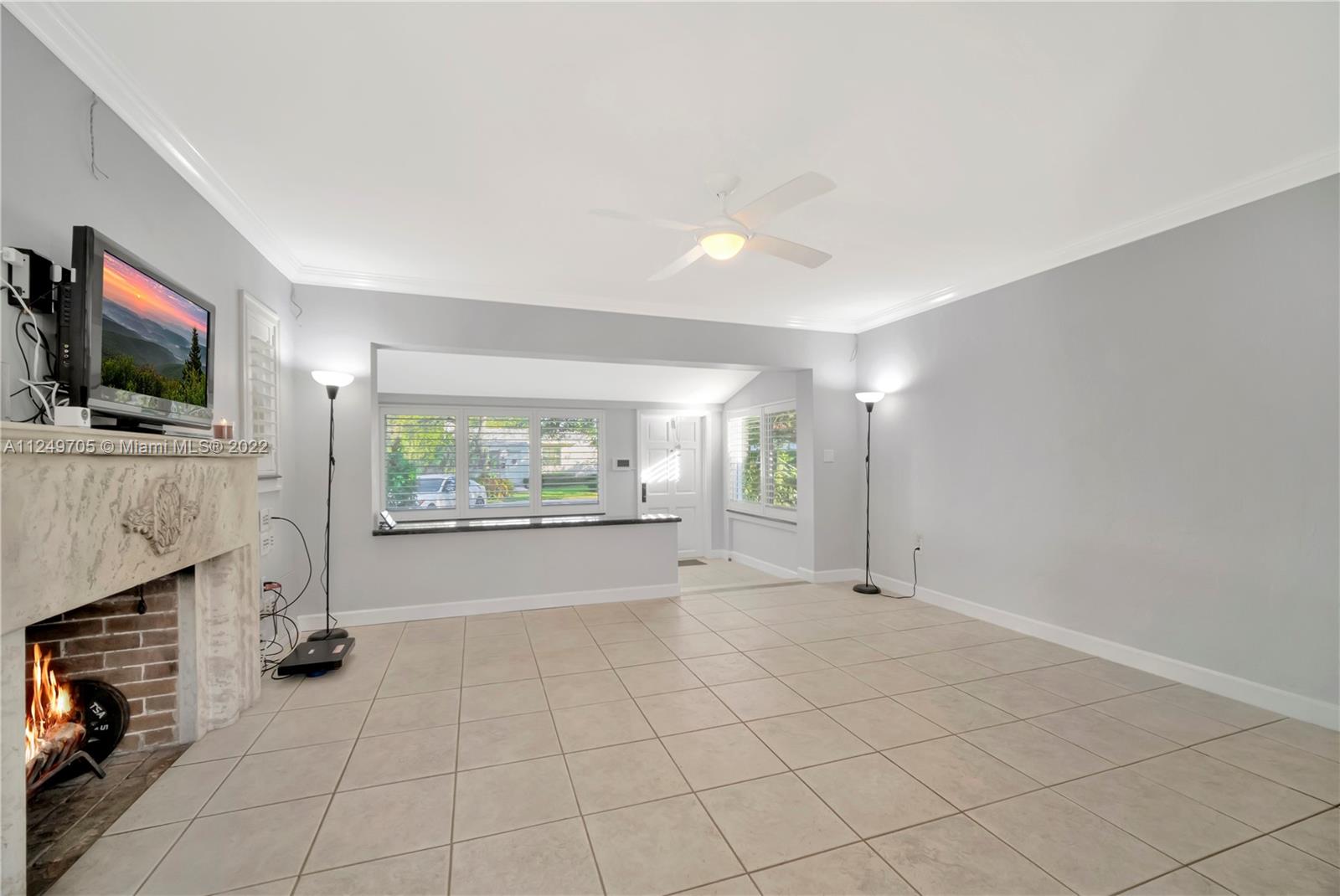 4290 Southwest 11th Street Miami, FL 33134 - Photo 7 of 20 a view of an empty room with a fireplace and a window