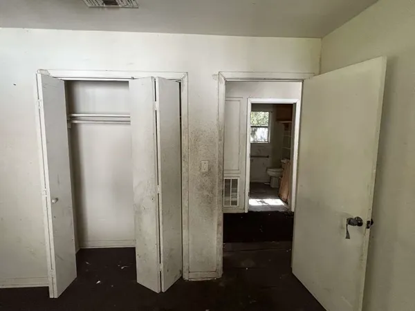 a view of a hallway with wooden floor and door