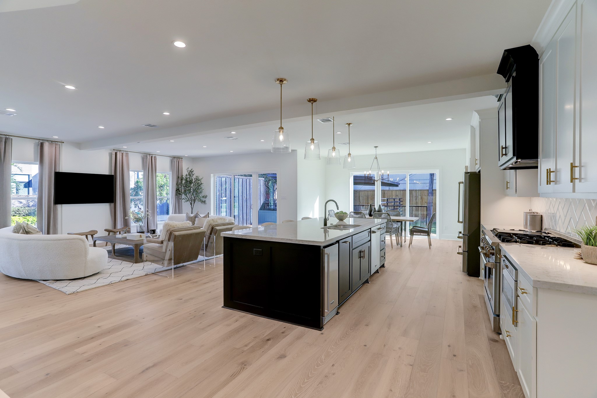 1601 Bonnie Brae Street Houston, TX 77006 - Photo 14 of 39 a kitchen with stainless steel appliances kitchen island granite countertop a stove top oven a sink a dining table and chairs with wooden floor