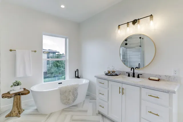a spacious bathroom with a double vanity sink mirror and