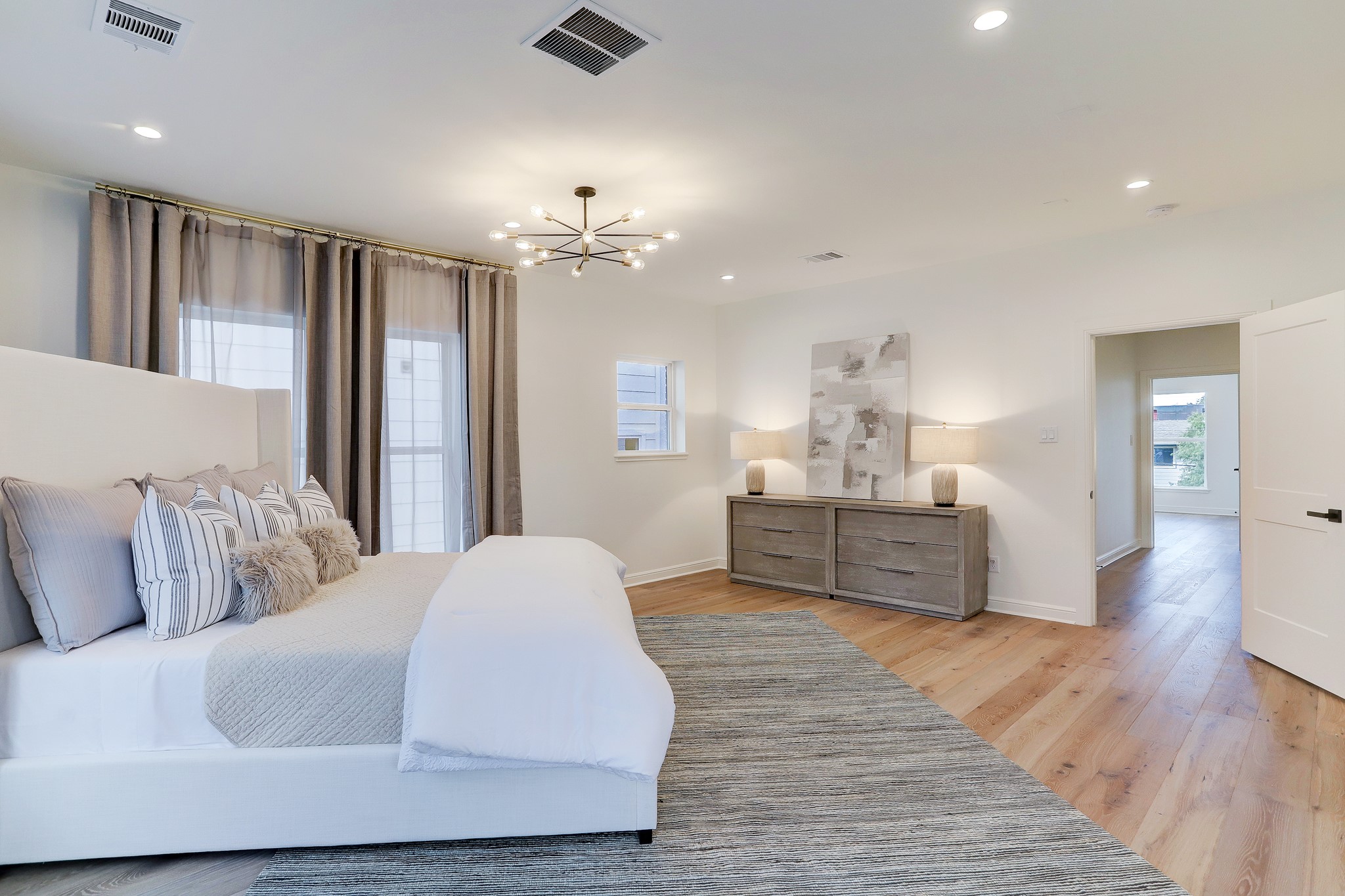 1601 Bonnie Brae Street Houston, TX 77006 - Photo 29 of 39 a spacious bedroom with a bed and wooden floor