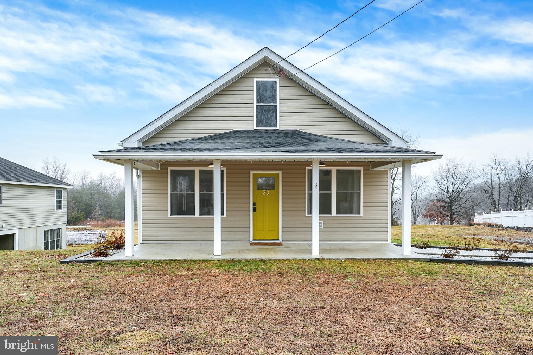 Charming home with a vibrant yellow door.