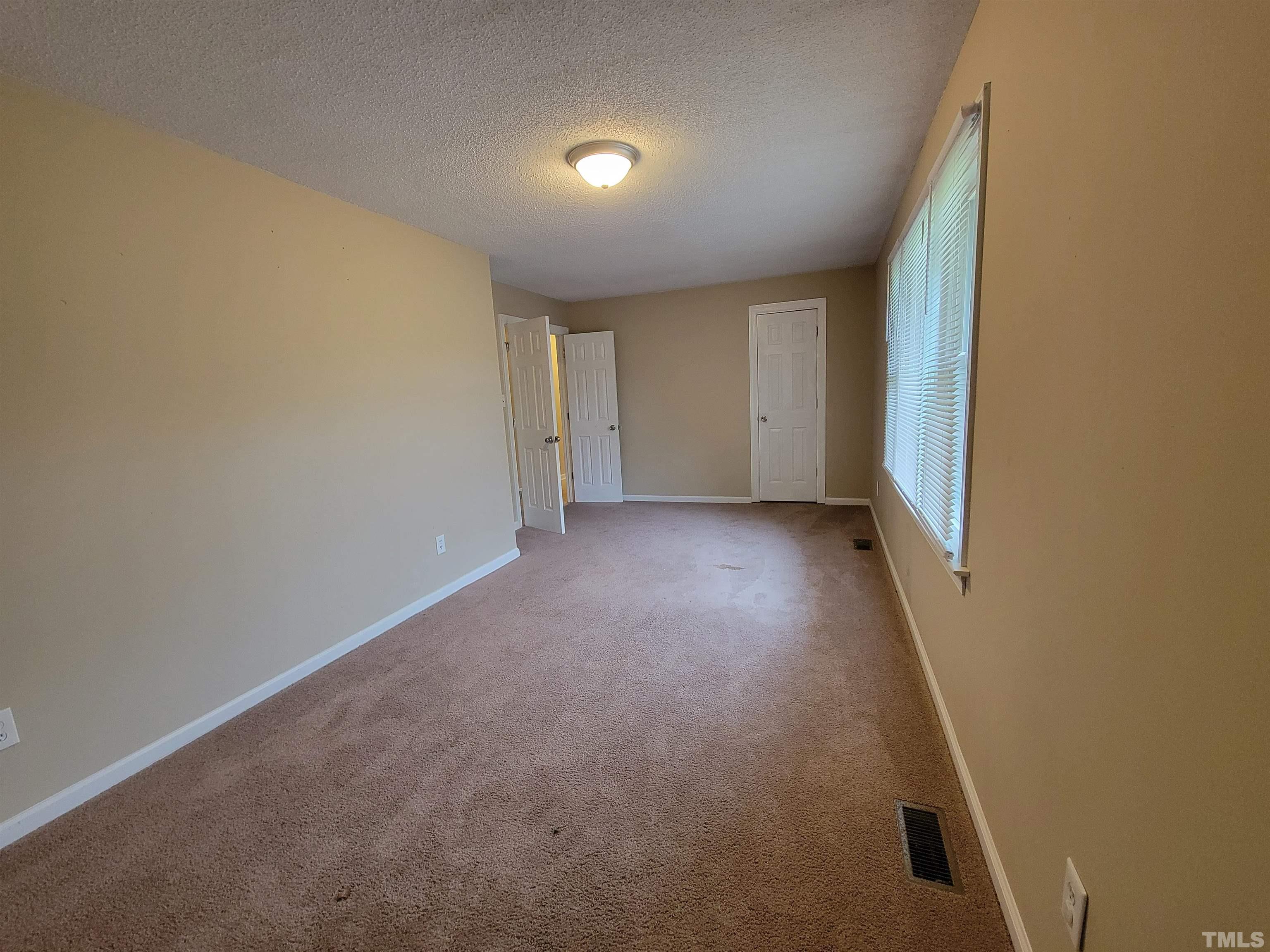 7137 Hodge Road Wendell, NC 27591 - Photo 9 of 31 an empty room with a empty space and windows