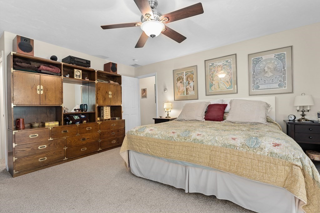 11 Longley Road, Unit H1 Shirley, MA 01464 - Photo 11 of 35 a bedroom with a large bed and a chandelier