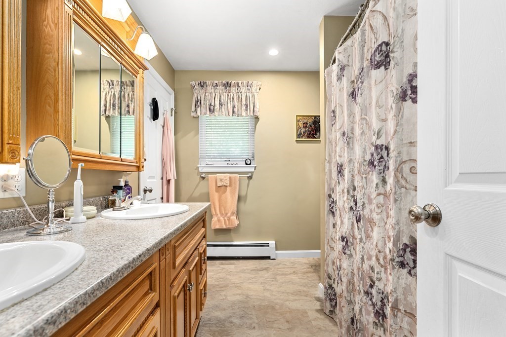 11 Longley Road, Unit H1 Shirley, MA 01464 - Photo 14 of 35 a bathroom with a granite countertop sink a toilet and a mirror