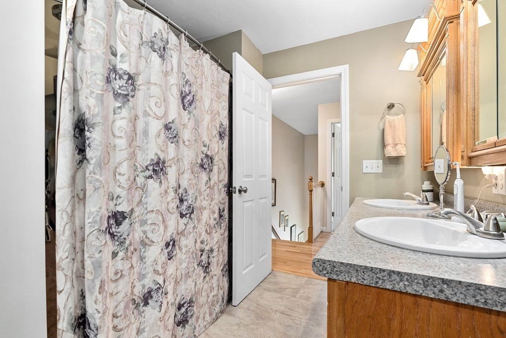 11 Longley Road, Unit H1 Shirley, MA 01464 - Photo 15 of 35 a bathroom with a granite countertop sink and a mirror