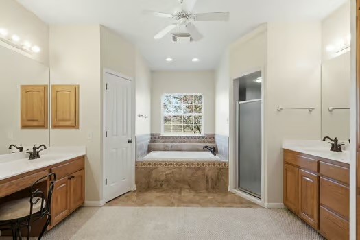 901 Kunde Road Seguin, TX 78155 - Photo 12 of 24 a spacious bathroom with a double vanity sink a large mirror and shower