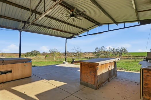 901 Kunde Road Seguin, TX 78155 - Photo 23 of 24 a view of a swimming pool with a lawn chairs under an umbrella