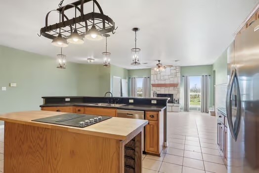 901 Kunde Road Seguin, TX 78155 - Photo 3 of 24 a kitchen with stainless steel appliances granite countertop a sink a stove and a refrigerator