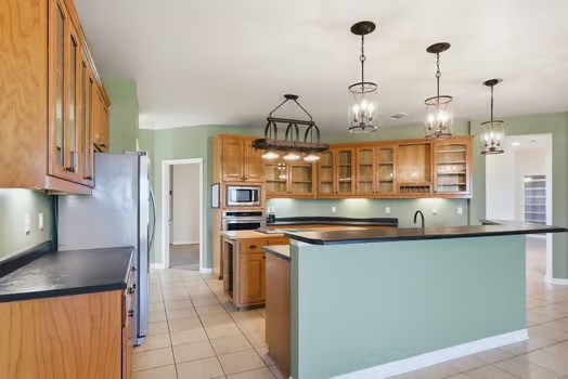 901 Kunde Road Seguin, TX 78155 - Photo 5 of 24 a kitchen with stainless steel appliances granite countertop a sink a stove and a wooden floors