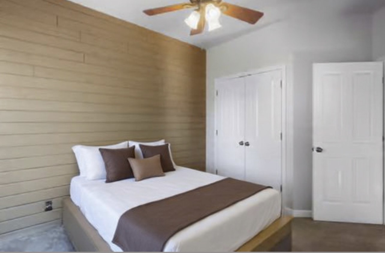 901 Kunde Road Seguin, TX 78155 - Photo 7 of 24 a bedroom with a bed and a chandelier