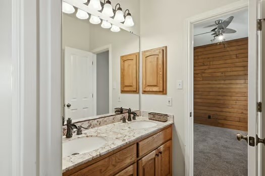 901 Kunde Road Seguin, TX 78155 - Photo 9 of 24 a bathroom with a granite countertop sink a mirror and a shower