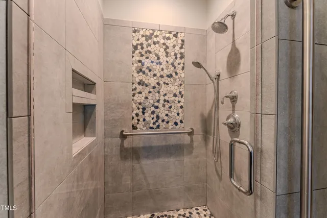 a bathroom with a granite countertop shower