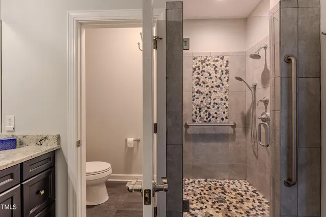 a bathroom with a shower toilet and a sink