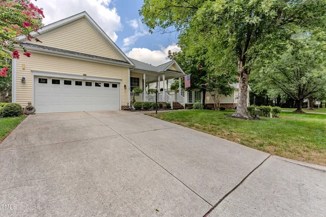 front view of a house with a yard and an trees