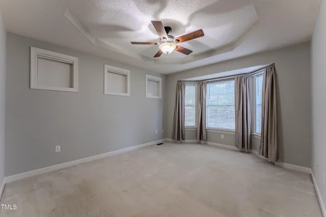 a view of a livingroom with a ceiling fan and window